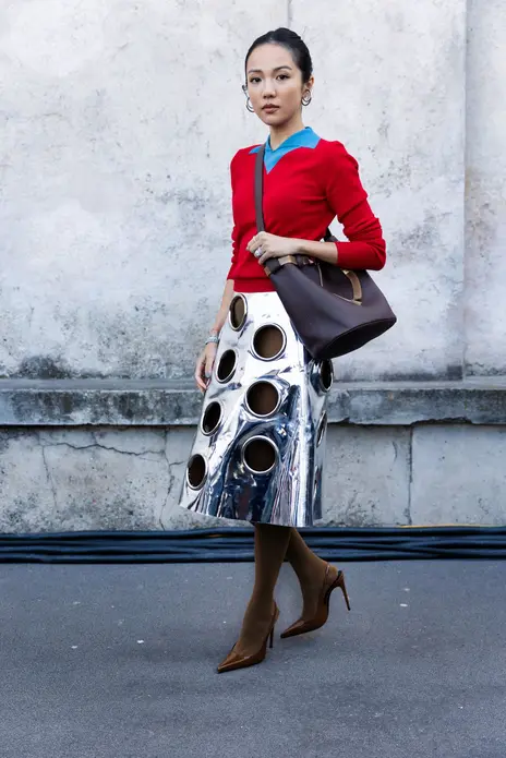 مهمان با سوئتر آبی‌کودک و قرمز، کیف چرمی با قفل Prada